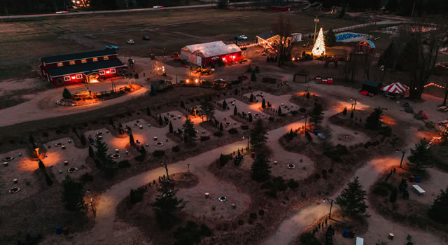Park at night with illuminated paths and campfire sites.